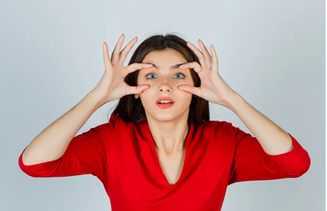 Young woman showing eye dryness and discomfort from contact lenses